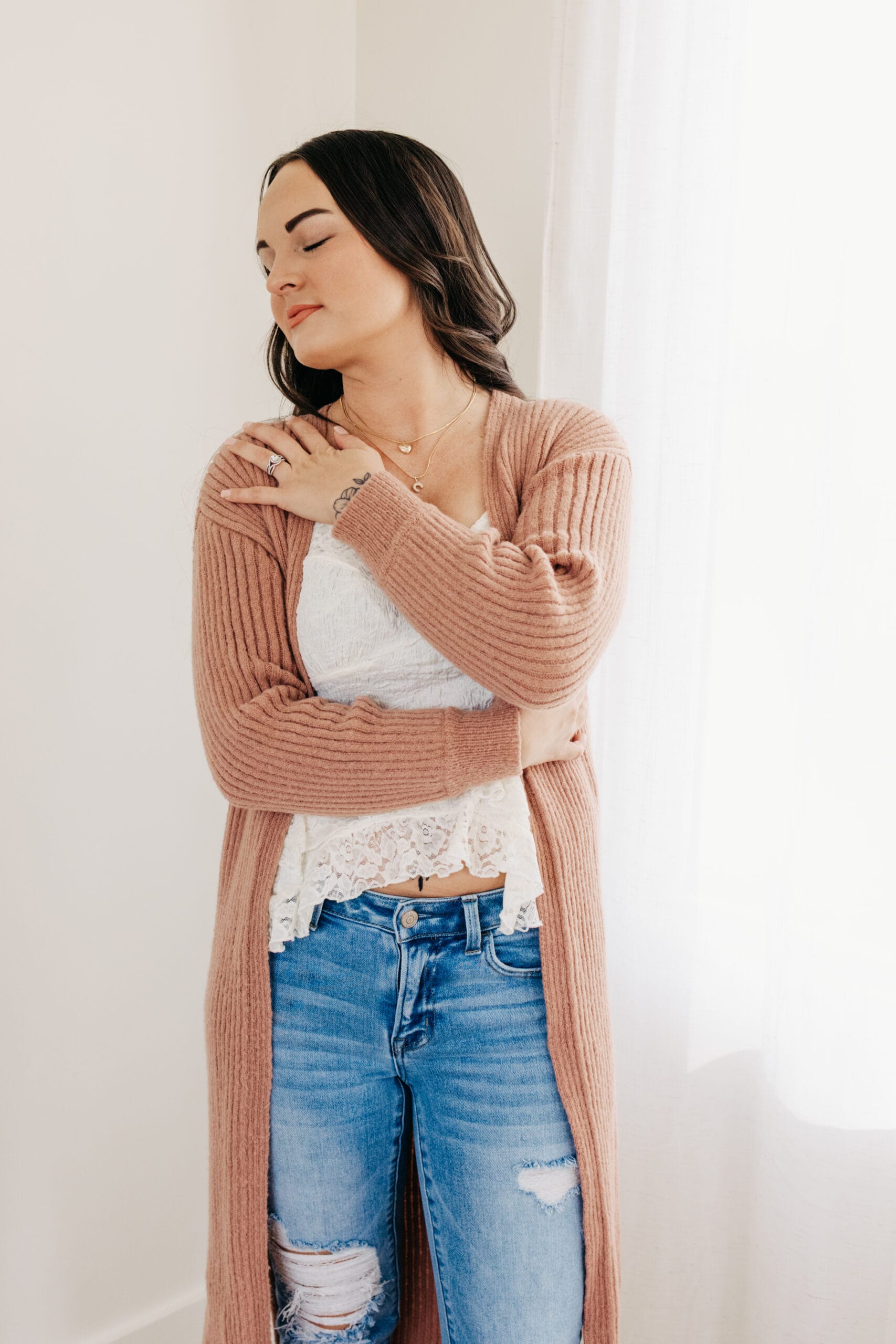 Woman embracing herself in a moment of self-connection and healing